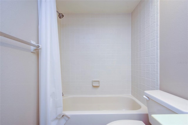 bathroom featuring shower / bath combination with curtain and toilet