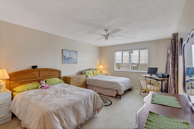 carpeted bedroom featuring a textured ceiling and ceiling fan