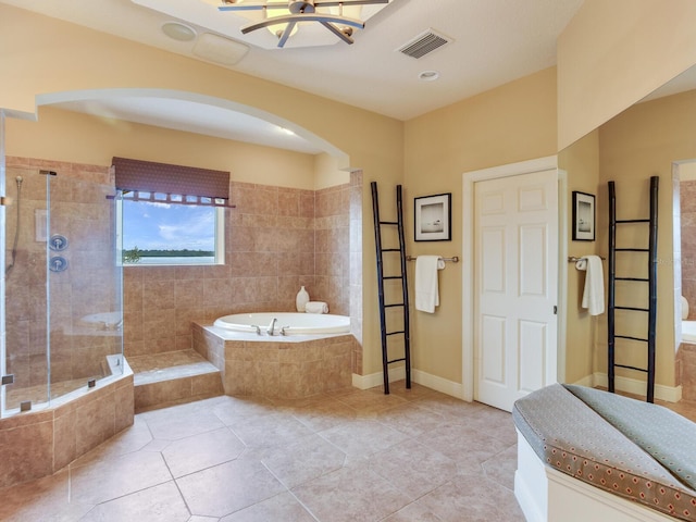 bathroom featuring tile patterned flooring, separate shower and tub, and a chandelier