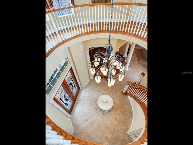 stairway featuring an inviting chandelier