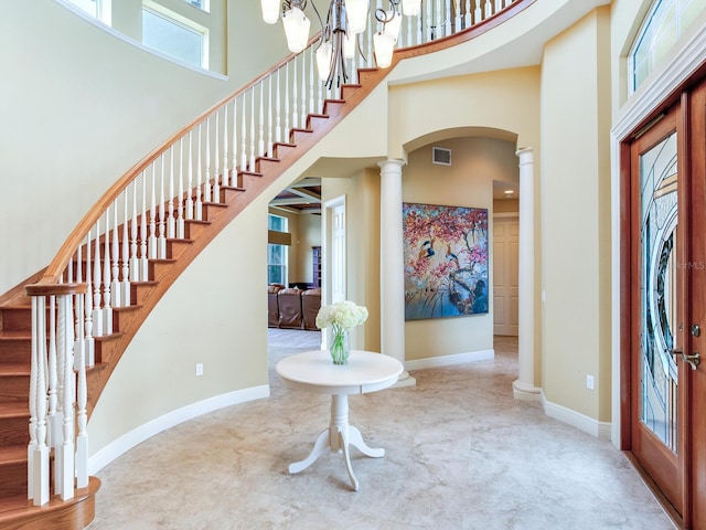 entrance foyer with a towering ceiling and decorative columns