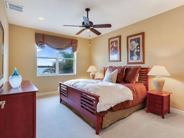 bedroom with ceiling fan and light colored carpet