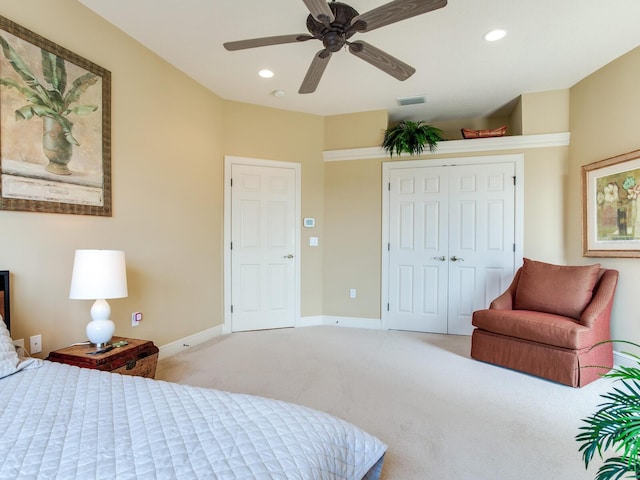 bedroom featuring light carpet, a closet, and ceiling fan