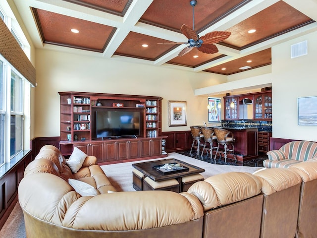 living room with light carpet, wood walls, beam ceiling, ceiling fan, and coffered ceiling