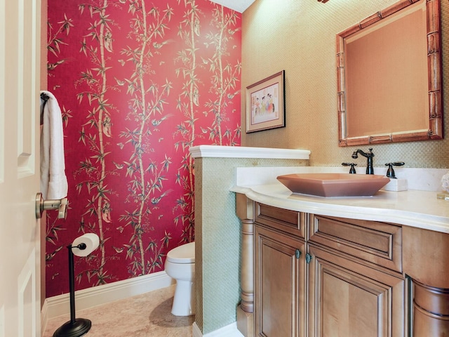 bathroom with toilet and vanity