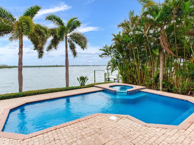 view of pool featuring an in ground hot tub and a water view