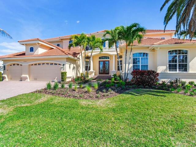 mediterranean / spanish-style house with a front lawn and a garage