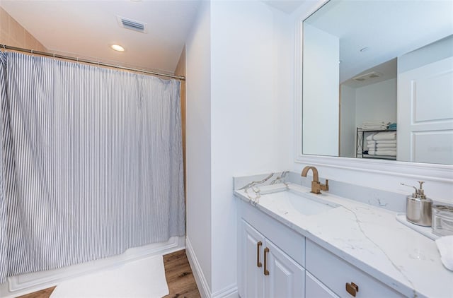 bathroom featuring vanity and hardwood / wood-style flooring