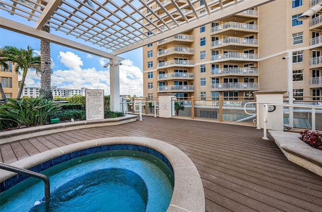 view of pool featuring a community hot tub and a pergola