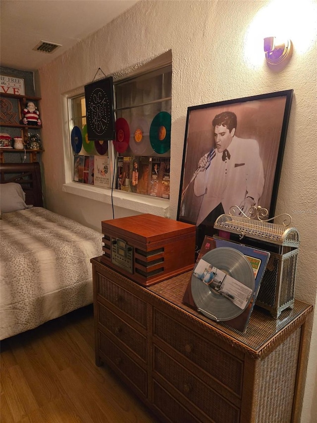 bedroom with wood-type flooring