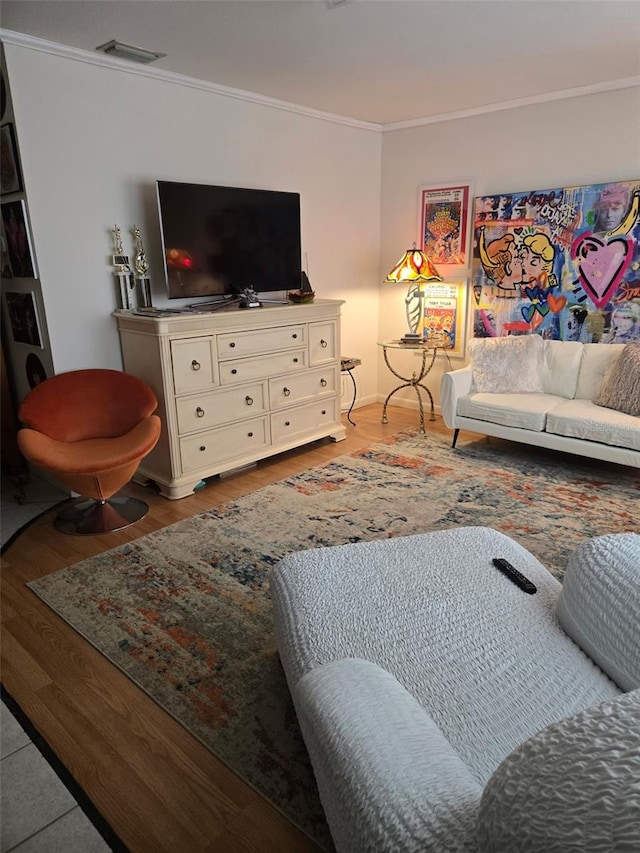 living room featuring hardwood / wood-style flooring and crown molding