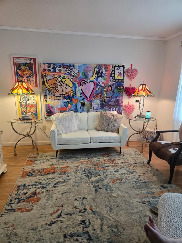 living room with hardwood / wood-style flooring and ornamental molding