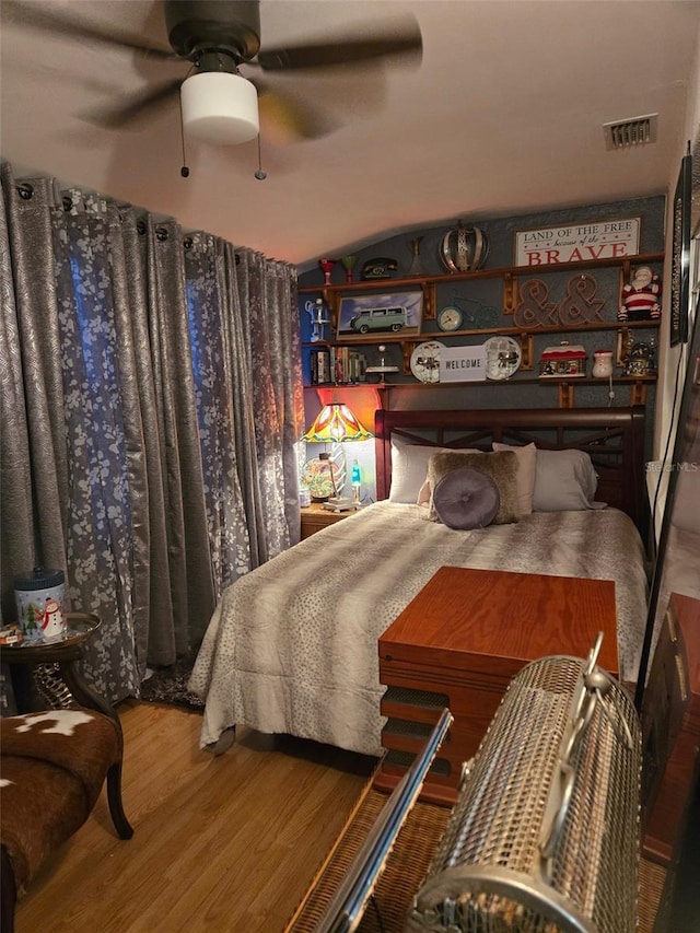 bedroom featuring lofted ceiling, hardwood / wood-style floors, and ceiling fan