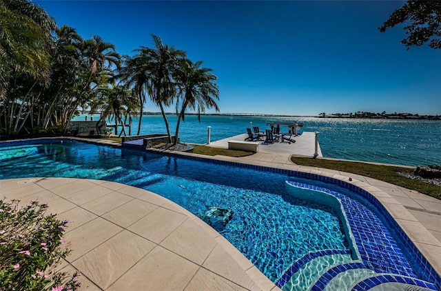 view of swimming pool featuring a water view and a patio