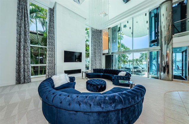 carpeted living room featuring a towering ceiling