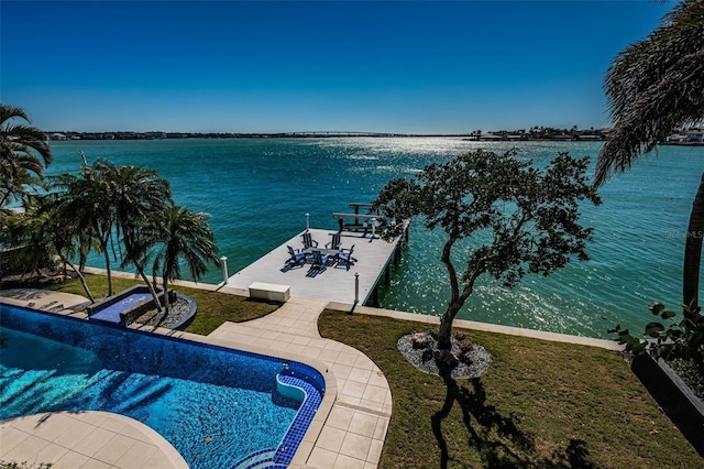 exterior space with a lawn, a water view, and a boat dock