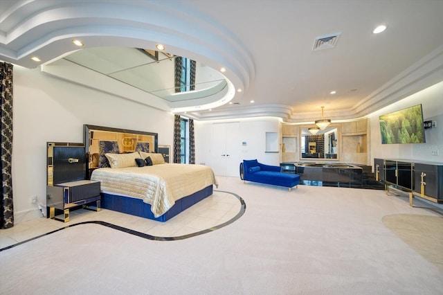 bedroom featuring light carpet and a raised ceiling