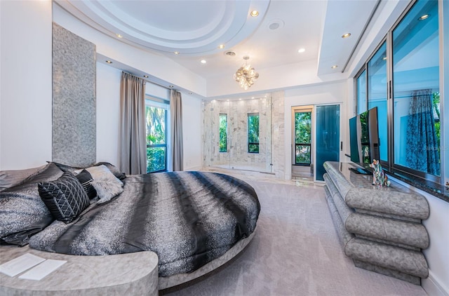 bedroom with carpet flooring, a chandelier, and a raised ceiling