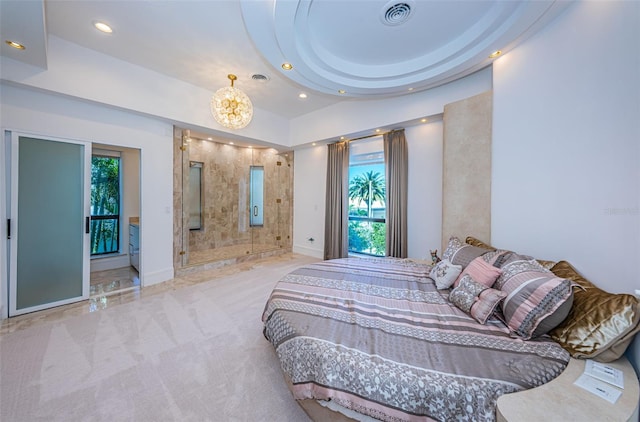 carpeted bedroom with a notable chandelier and a tray ceiling