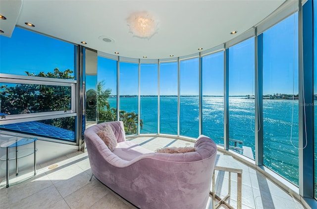 sunroom / solarium with a water view