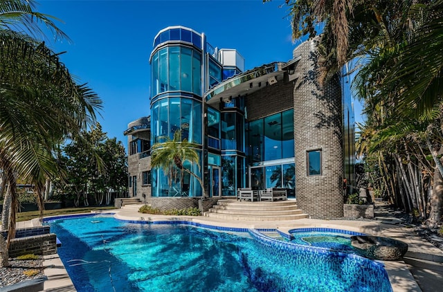 view of pool with an in ground hot tub