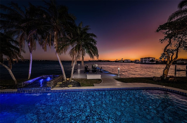 pool at dusk with a water view