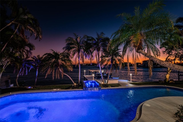 view of pool at dusk