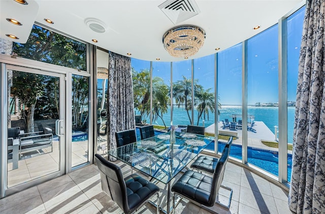 sunroom / solarium featuring visible vents and a water view