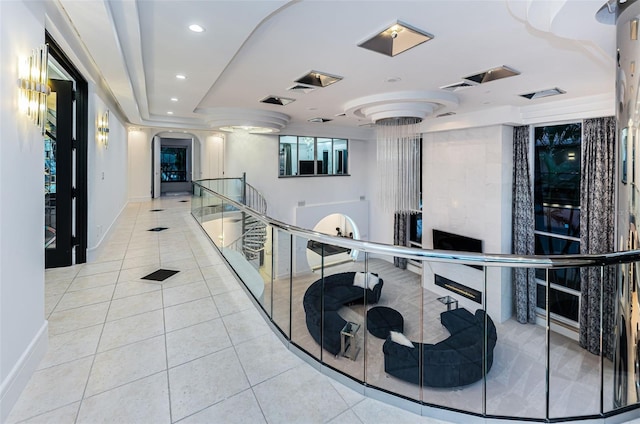 hall featuring arched walkways, recessed lighting, visible vents, baseboards, and tile patterned floors