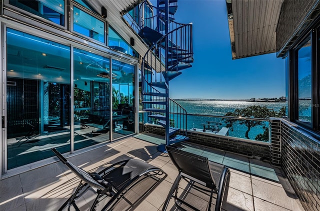 balcony featuring a water view and stairs