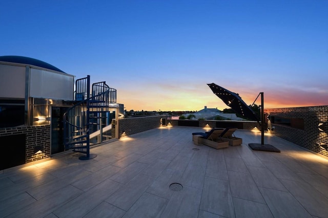 view of patio terrace at dusk