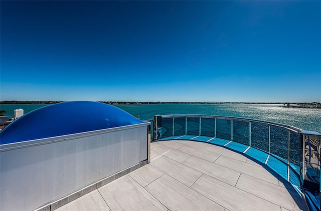 view of patio with a pool and a water view