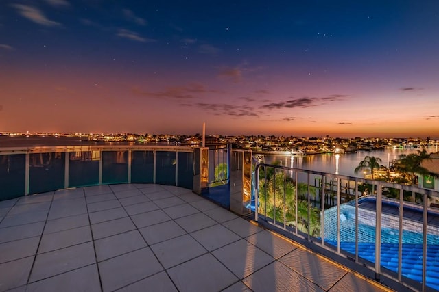 view of patio / terrace featuring a balcony and a water view