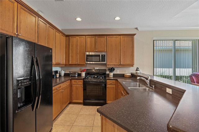 kitchen with light tile floors, a textured ceiling, ornamental molding, black appliances, and sink