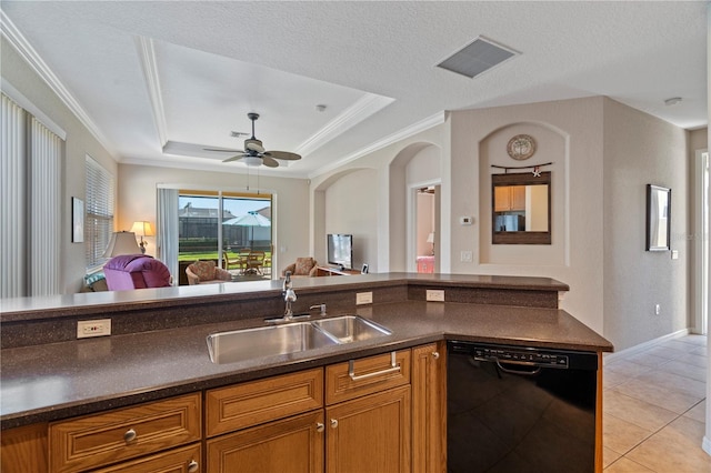 kitchen with light tile floors, ceiling fan, a tray ceiling, dishwasher, and sink