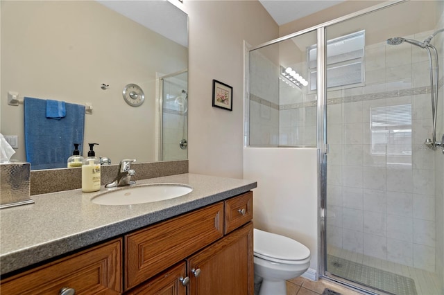 bathroom with toilet, a shower with door, tile floors, and vanity