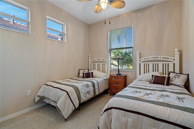 bedroom featuring light carpet and ceiling fan