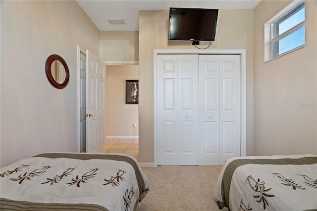 bedroom with a closet and light colored carpet