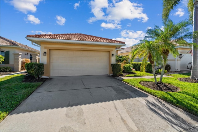 mediterranean / spanish-style home with a front lawn and a garage