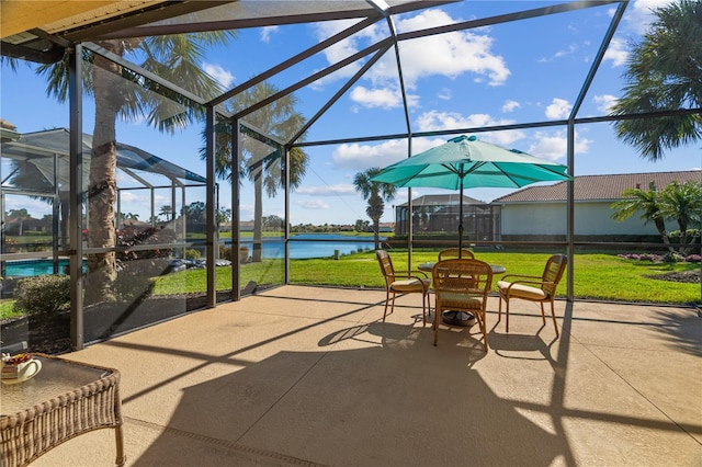 sunroom featuring a water view