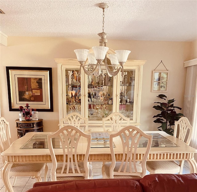 dining area featuring a textured ceiling and an inviting chandelier