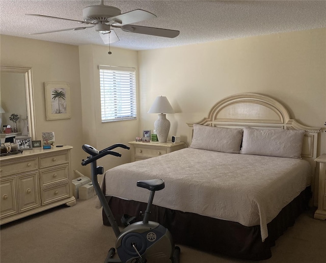 carpeted bedroom featuring a textured ceiling and ceiling fan