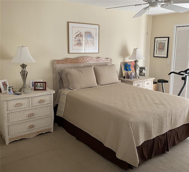 carpeted bedroom featuring a textured ceiling and ceiling fan