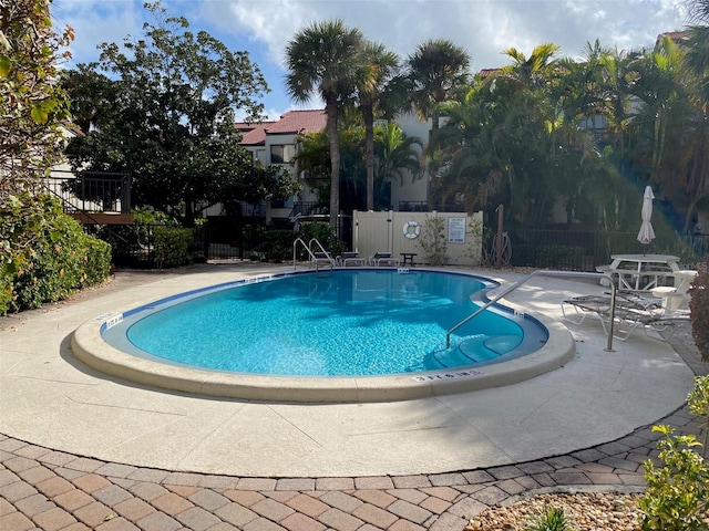 view of swimming pool featuring a patio area