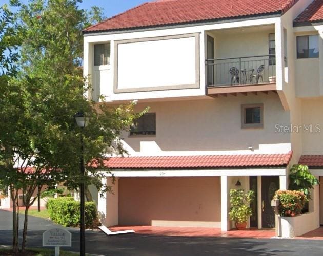 exterior space featuring a balcony and a garage