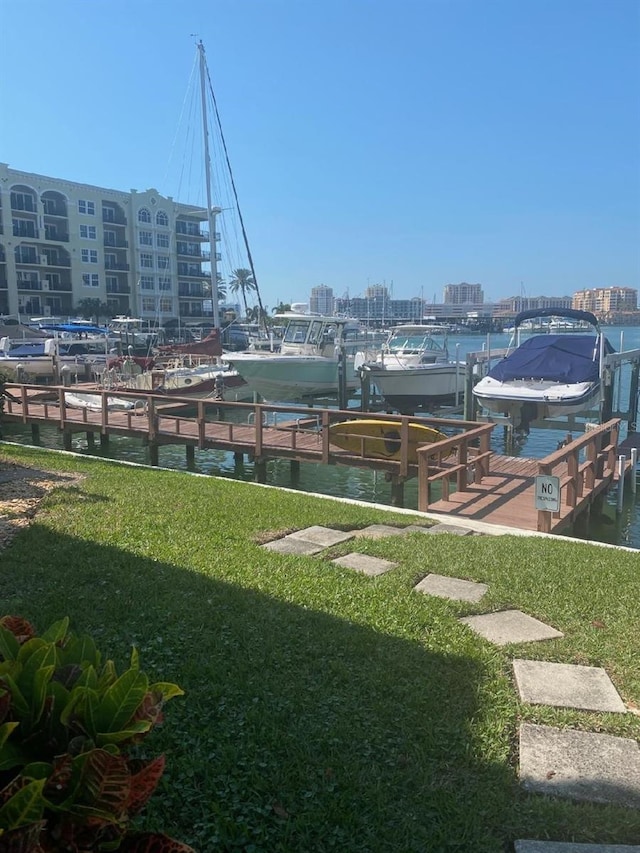 view of yard featuring a water view and a boat dock