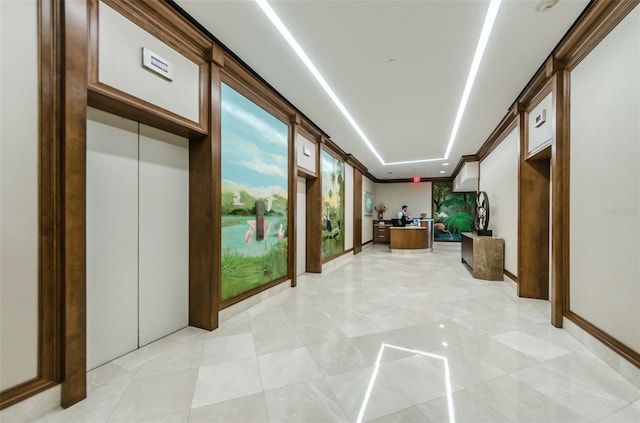 hall featuring a barn door and light tile floors