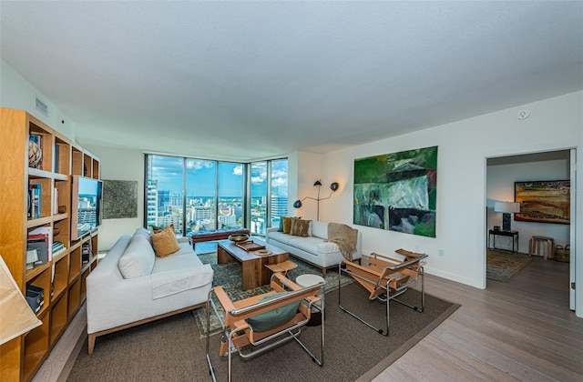 living room with floor to ceiling windows and wood-type flooring