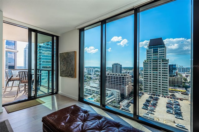 interior space featuring a wall of windows and light hardwood / wood-style flooring