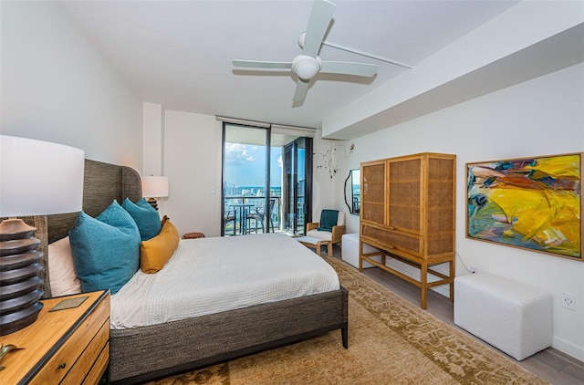 bedroom featuring access to exterior, floor to ceiling windows, light hardwood / wood-style floors, and ceiling fan